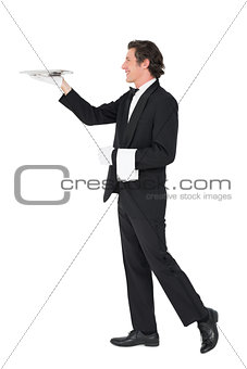 Waiter carrying tray over white background