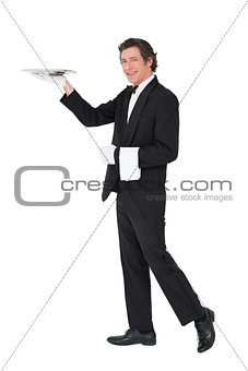 Server carrying tray over white background