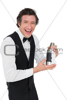 Bartender using cocktail shaker against white background