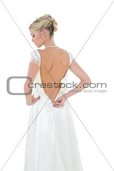 Bride getting dressed against white background
