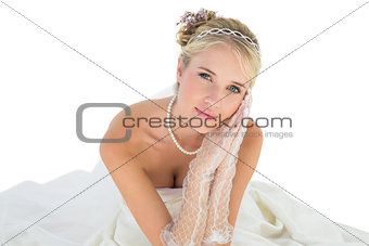 Bride with hands clasped over white background