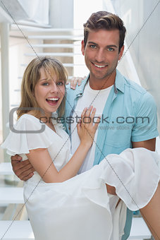 Portrait of a smiling man carrying woman