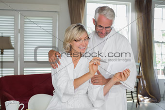 Mature couple with bills at home