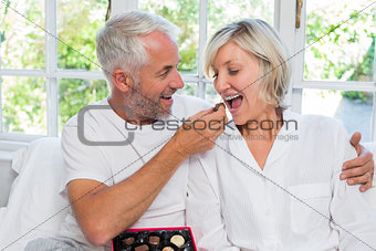 Mature man feeding woman chocolates