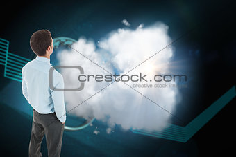 Composite image of businessman standing with hands in pockets