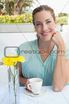 Portrait of a beautiful woman drinking at café