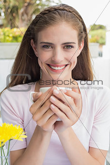 Beautiful woman drinking coffee at café
