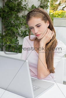 Beautiful woman using laptop at café