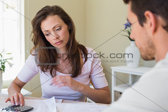 Woman and man sitting with home bills at table