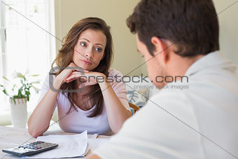 Young couple with home bills at table