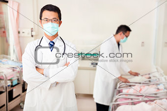 doctor and assistant care newborn babys  in baby room 
