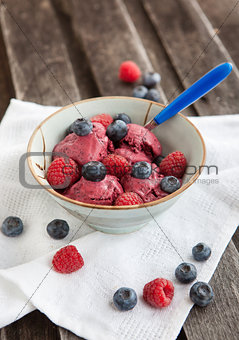 Berry ice cream decorated with fresh blueberries and raspberries