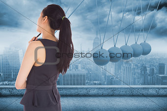 Composite image of thoughtful asian businesswoman