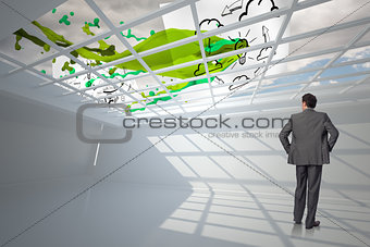 Composite image of businessman with hands on hips