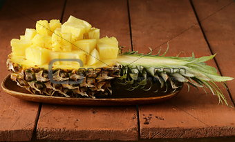 dessert pineapple sliced on a wooden plate