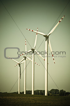 Wind turbine farm on rural terrain