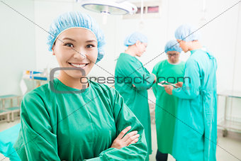 surgeon standing in front of a colleague in a surgical room