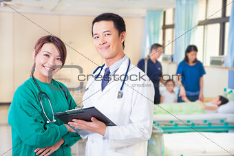 smiling doctor and assistant with patient