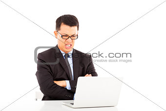 ireful businessman sitting and cross arms