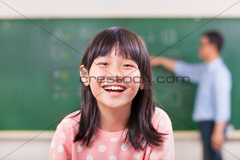 happy pupils smiling in class with teacher