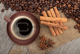 Coffee cup and spices on wooden table
