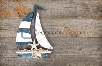 Toy sailboat on a wooden background