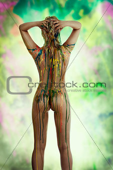 blond nude girl with multicolor over her body posing from back v