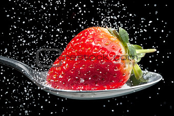 Strawberry sprinkled with sugar close up