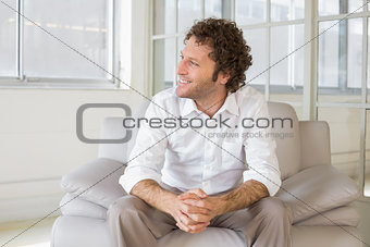 Relaxed well dressed man sitting at home