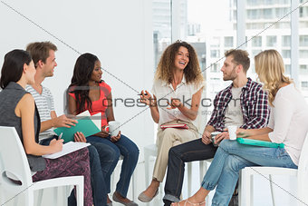 Smiling therapist speaking to a rehab group