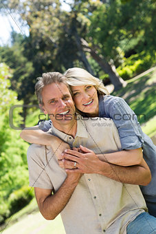 Couple with arm around in park