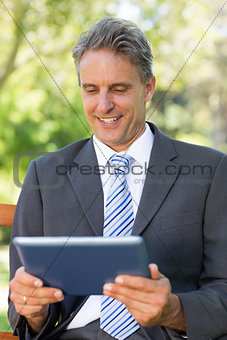Happy businessman using digital tablet
