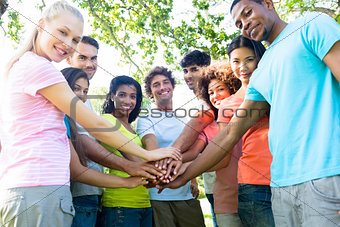 Multiethnic friends stacking hands