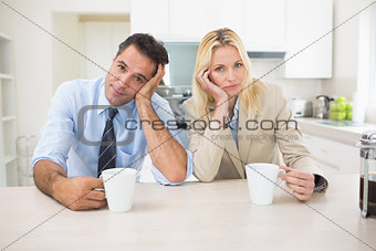 Portrait of well dressed couple  with coffee cups in kitchen