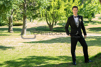 Confident groom standing in garden