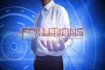 Businessman presenting the word solutions