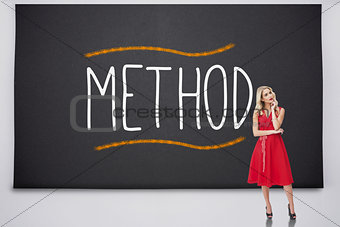 Pretty blonde standing against the word method