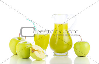 Fresh apples, glass with juice and carafe