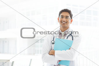 Asian Indian male medical doctor holding file folder