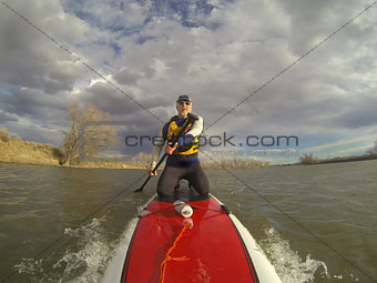 kneeling on stand up paddleboard