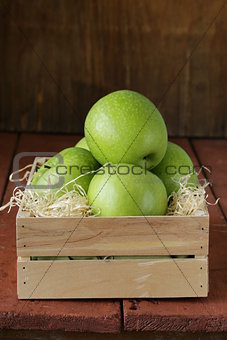 Granny Smith green apples in a wooden box