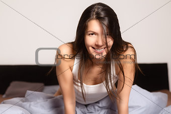 Refreshed young woman awaking in the morning