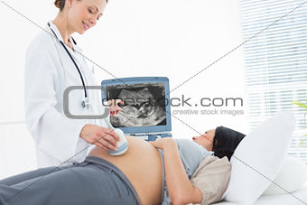 Doctor doing ultrasound pregnant woman