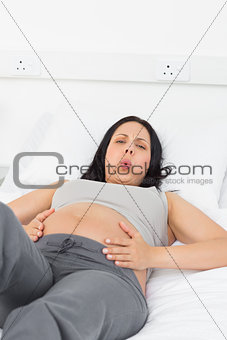 Portrait of pregnant woman suffering from pain