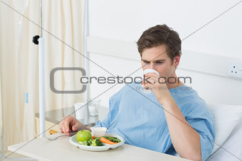 Male patient having meal in hospital