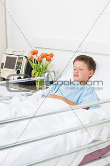 Boy resting in hospital ward