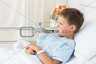 Boy in hospital with thermometer in mouth