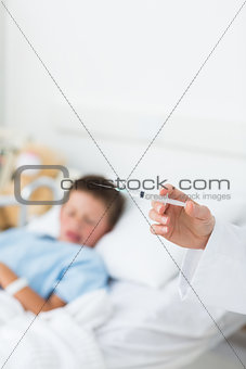 Doctor holding syringe with boy in hospital