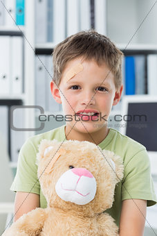 Boy with teddy bear in clinic