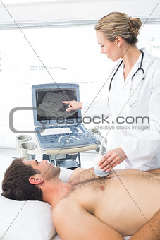 Doctor using sonogram on male patient